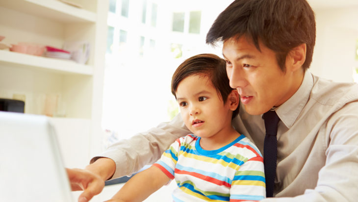 Father and young son using the computer