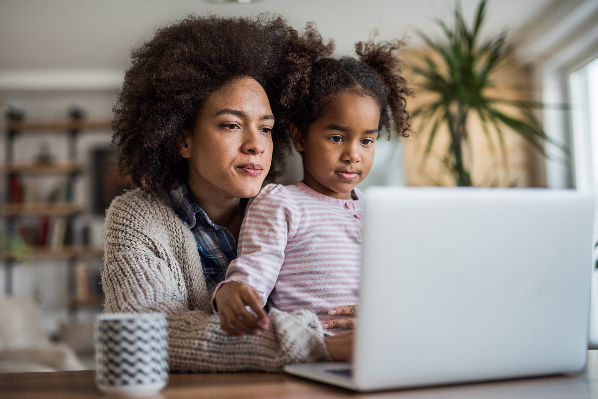 Parent on laptop with child