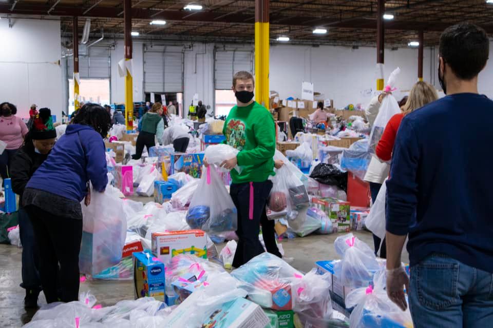 Volunteers sort gifts for the Clark's Christmas Kids program
