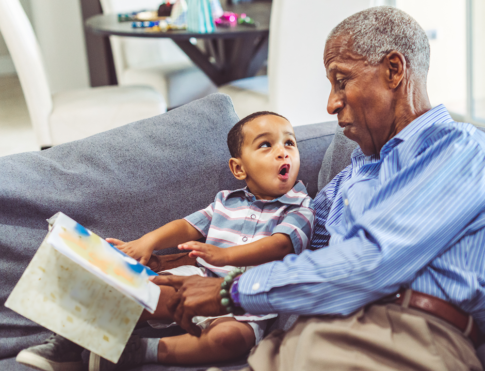 Grandfather reading with grandson