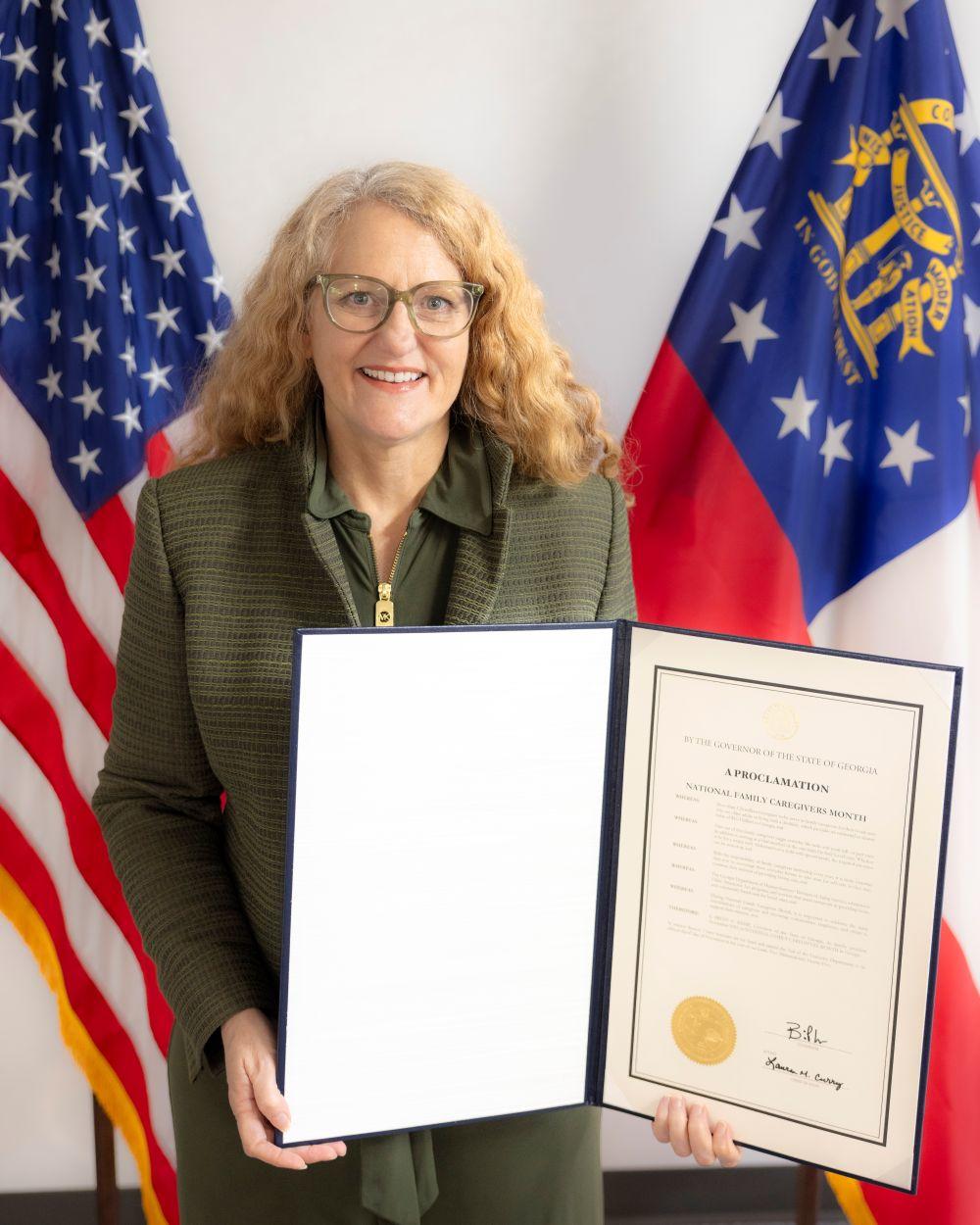 Assistant Deputy Commissioner MaryLea Boatwright Quinn with Governor Kemp's National Family Caregivers Month Proclamation